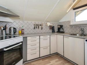 a kitchen with white cabinets and a sink at 8 person holiday home in Hemmet in Hemmet