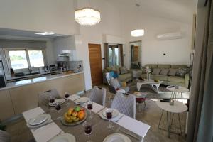 a living room with a table with fruit on it at Yulya Villa By Taimoura in Paphos