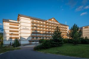 a large building with a road in front of it at Apartmanica Residence 606 in Donovaly