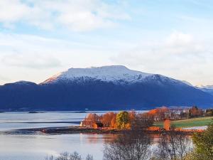 a large body of water with a mountain in the background at 6 person holiday home in Frei in Frei