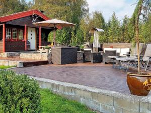 a patio with a table and chairs and an umbrella at 6 person holiday home in Frei in Frei