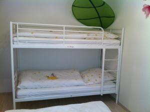 a white bunk bed with a basketball on the wall at A Little Home in Rust