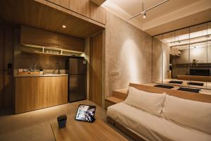 a small bedroom with a bed and a kitchen at Nostoi in Jakarta