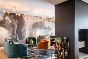 a lobby with couches and chairs and a wall at Camissa House in Cape Town