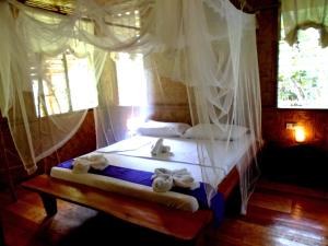 Katil atau katil-katil dalam bilik di Nypa Style Resort Camiguin