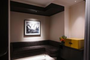 
a living room with a painting on the wall at Grand Park City Hall (SG Clean) in Singapore
