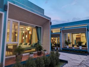 a house with large glass doors and a patio at เดอะชาลี The Charlie in Nan