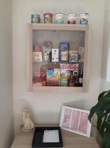 a shelf in a kitchen with food in it at Stay in Kaunas - Free Parking in Kaunas