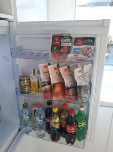 a refrigerator filled with lots of food and drinks at Stay in Kaunas - Free Parking in Kaunas