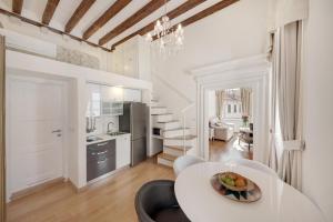 a kitchen with a table, chairs, and a refrigerator at Apartments More in Dubrovnik