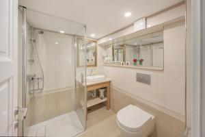 a bathroom with a toilet and a shower and a sink at Palmotta Palace in Dubrovnik