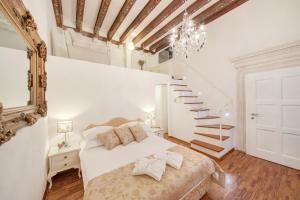 a bedroom with a bed and a staircase at Palmotta Palace in Dubrovnik