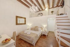 a bedroom with a bed and a chandelier at Palmotta Palace in Dubrovnik