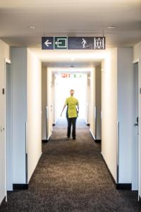 a man walking down a corridor in a hospital hallway at Let's Meet Elewijt in Elewijt