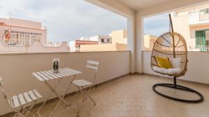 a room with a chair and a table on a balcony at Italianway - Ottoventi Apartments in Lampedusa