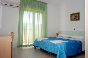 Postel nebo postele na pokoji v ubytování Long Beach Village Residence sul mare spiaggia privata inclusa + 37 fotografií