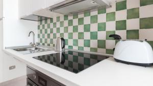 a kitchen with a sink and a toaster on a counter at Italianway - Ottoventi Apartments in Lampedusa