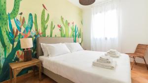 a bedroom with a bed and a mural of fishes at Italianway - Ottoventi Apartments in Lampedusa