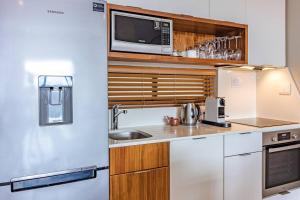 a kitchen with a sink and a microwave at Suite 501, Zimbali Suites in Ballito