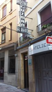 a building with a sign on the side of it at Hostal Guzmán El Bueno in León