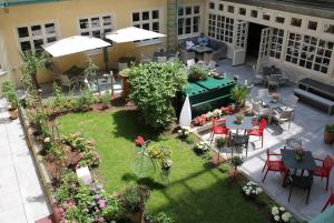 an overhead view of a garden with tables and chairs at Hotel Josefshof am Rathaus in Vienna