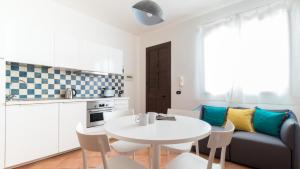 a kitchen and a living room with a table and a couch at Italianway - Ottoventi Apartments in Lampedusa