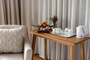a wooden table with a tray of food on it at Oceans Guest House & Luxurious Apartments in Struisbaai