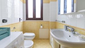 a bathroom with a sink and a toilet at Italianway - Ottoventi Apartments in Lampedusa