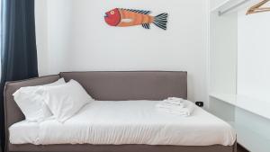 a bed with a fish on the wall above it at Italianway - Ottoventi Apartments in Lampedusa