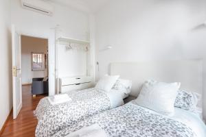 two beds in a room with white walls at Stay In Rome in Rome