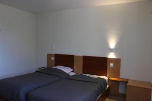 Postel nebo postele na pokoji v ubytování Auberge Au Lion d'Or