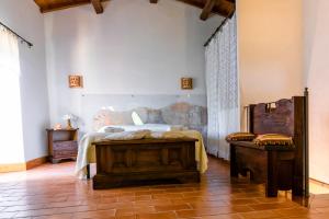 La Casetta Madonna di Morciano tesisinde bir odada yatak veya yataklar
