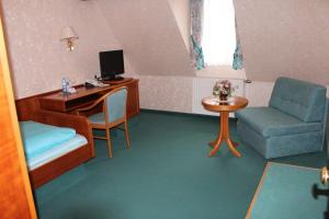 Zimmer mit einem Schreibtisch, einem Computer und einem Stuhl in der Unterkunft Gästehaus Wild in Oberasbach