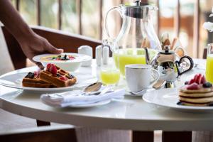 a table topped with plates of breakfast foods and drinks at Jumeirah Al Naseem Dubai in Dubai