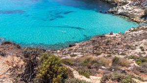 an aerial view of a beach with blue water at Italianway - Ottoventi Apartments in Lampedusa