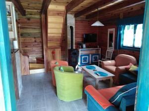 a living room with couches and a fireplace in a cabin at Apartment Bajka in Mokra Gora