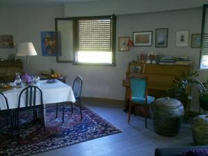 a dining room with a table and chairs and a window at Chambre d'hôte Les Jardins Du Forcone in Ajaccio