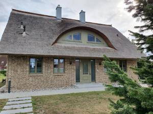 a dog sitting on the roof of a house at Ferienhaus Schütt in Zempin