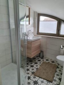 a bathroom with a shower and a sink at Ferienhaus Schütt in Zempin +35 photos