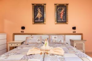 a bedroom with a bed with a bow on it at Villas El Paraiso in Morro del Jable