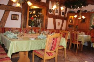 a dining room with a table and chairs with glasses at Gästehaus Wild in Oberasbach
