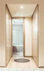 a bathroom with a sliding door leading to a bath tub at Marina Rabat Suites & Apartments in Sale