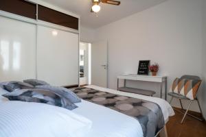 a bedroom with a bed and a desk and a chair at Apartment Lassy by Irundo in Rovinj