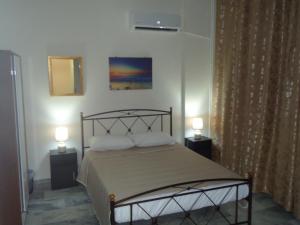 a bedroom with a bed with two night stands and two lamps at Original house in Larisa
