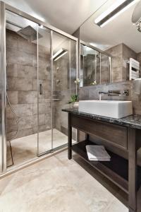 a bathroom with a sink and a shower at Red Baron Hotel & Restaurant in Świdnica