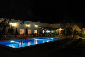 a swimming pool in front of a building at night at Soller Garden in Port de Soller