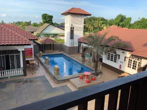 an aerial view of a house with a swimming pool at Wan Danisha Villa Inn in Kota Bharu