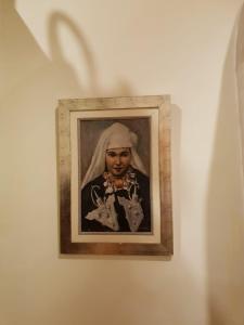a picture of a woman on a wall at Riad Les Trois Palmiers El Bacha in Marrakech
