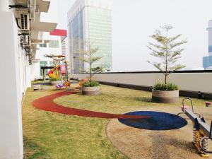 a building with a large circle in the grass at Delight Homestay Twin Galaxy Studio Room in Johor Bahru