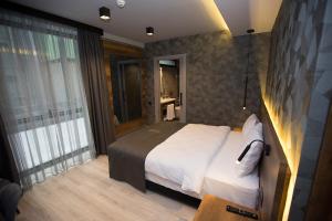 מיטה או מיטות בחדר ב-Emens hotel